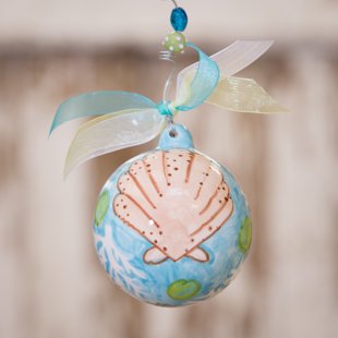 Beach Shell Ball Ornament. Shell Porcelain Ball Christmas Ornament From Glory Haus Is a Beautiful Treasure to Help You Remember Your Beach Trip. Personalize Making the Ornament Extra Special and a Perfect Gift! Comes with a Decorative Ribbon.
