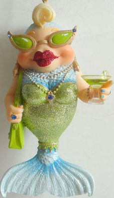 December Diamonds Miss Tuna Mermaid Ornament.She is at Happy Hour with Cocktail in Hand-Pointed Tip Gold Cat Eye Sunglasses with “Sapphire” Rhinestone Accents, & Lime Green Lens. Large Red Glittered Lips & Blond Curl on the Top of her Head! Hand Painted, Gift Boxed Limited Edition.