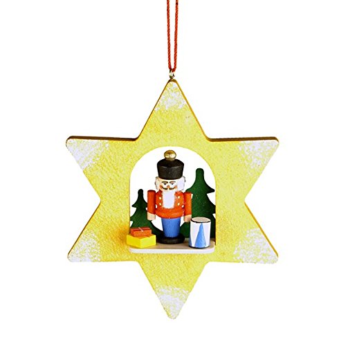 10-0457 – Christian Ulbricht Ornament – Nutcracker in Yellow Star – 4″”H x 3.25″”W x 1″”D